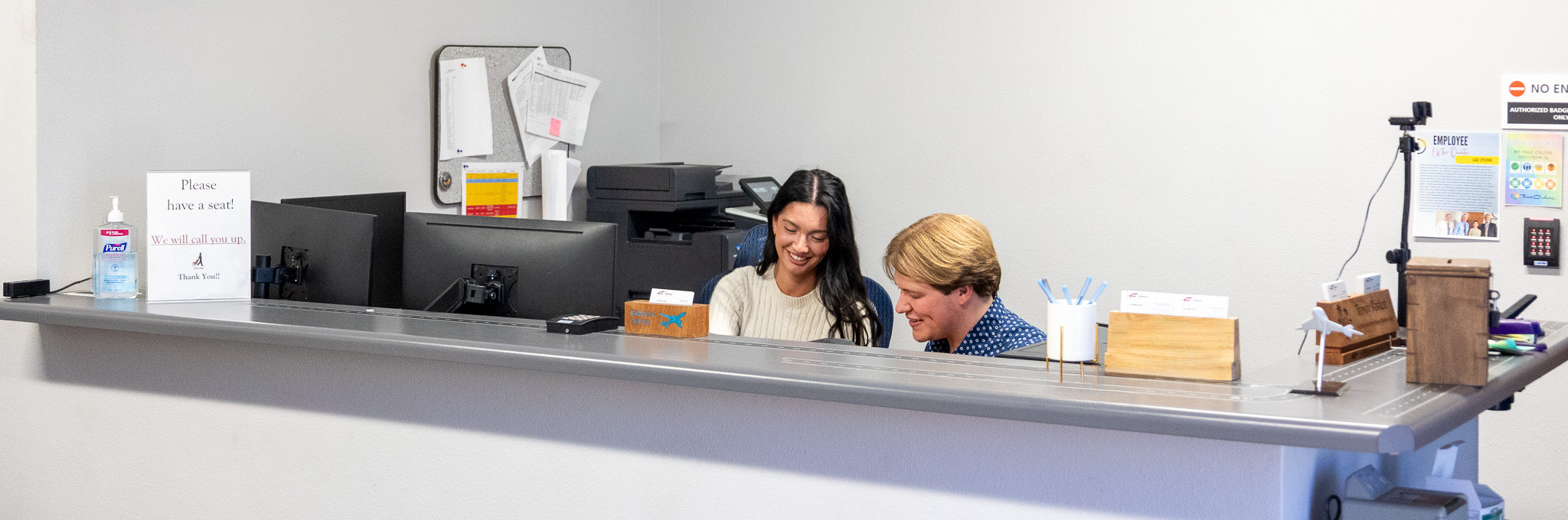 Staff assisting a visitor at the Badging Office counter