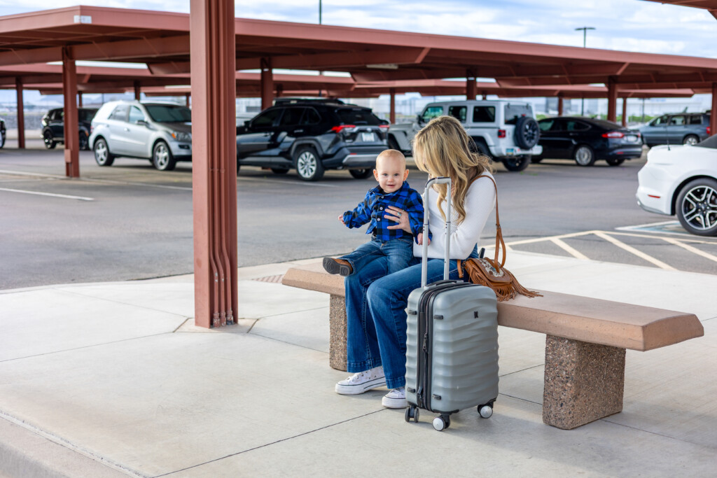 Mother and child waiting on a bench in the covered parking area
