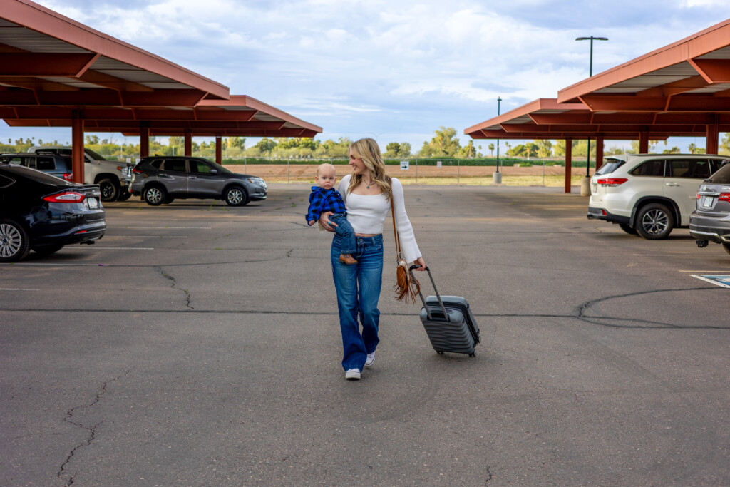 Traveler pulling luggage through the covered parking lot