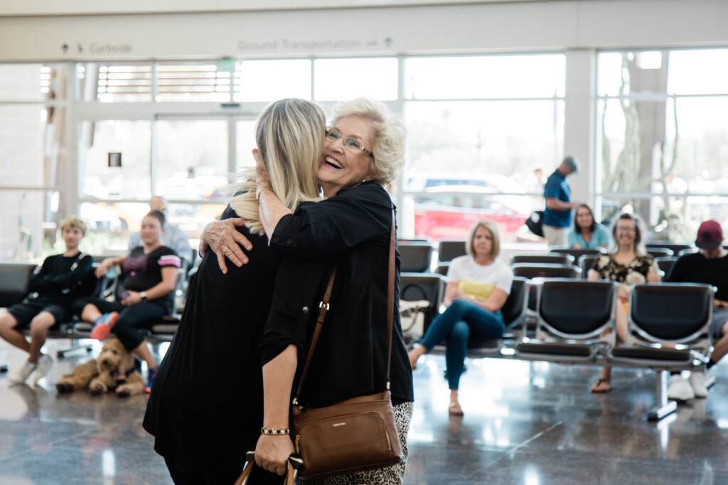 Two people embracing in the gate area