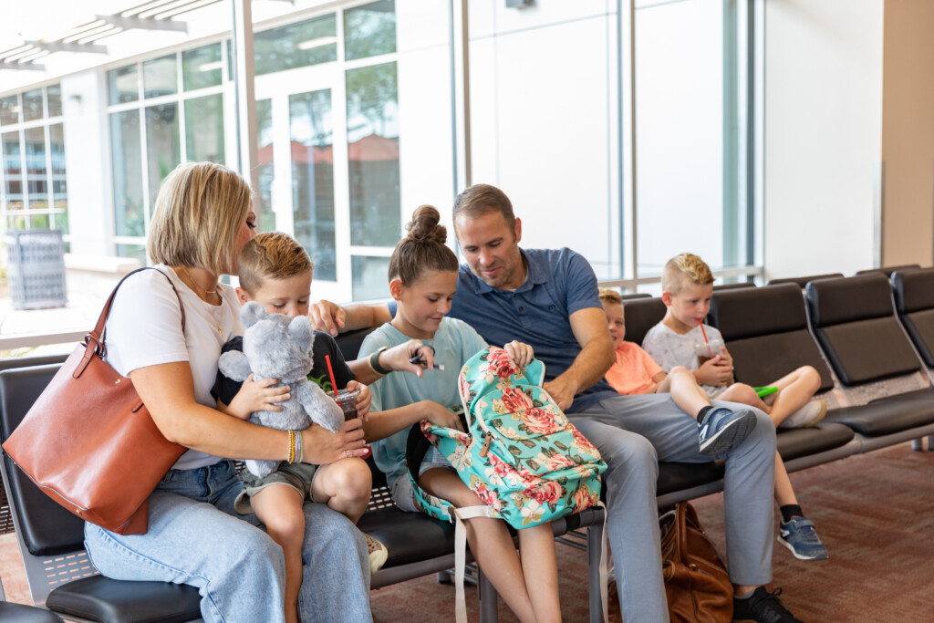 Family with young children relaxing in gate seating