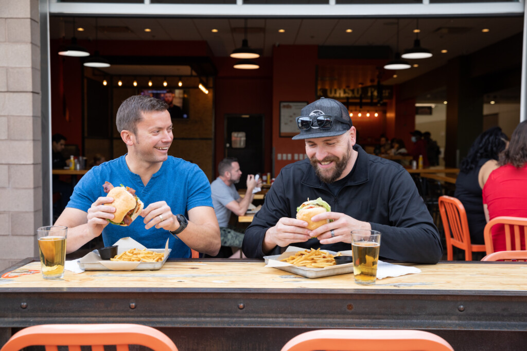 Two friends eating lunch at a terminal restaurant