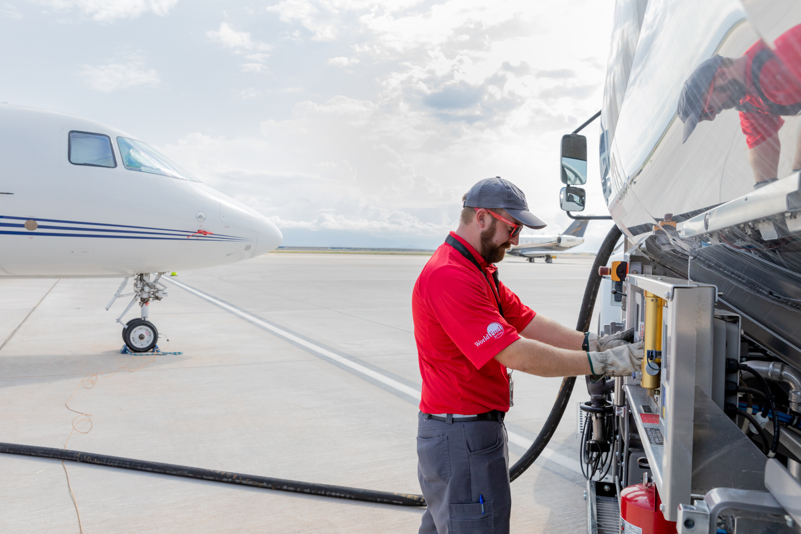 Technician fueling a private jet