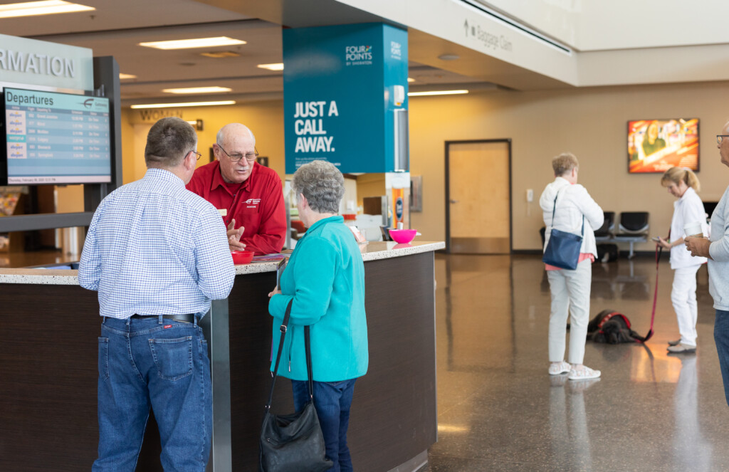 Travelers getting help at the information desk