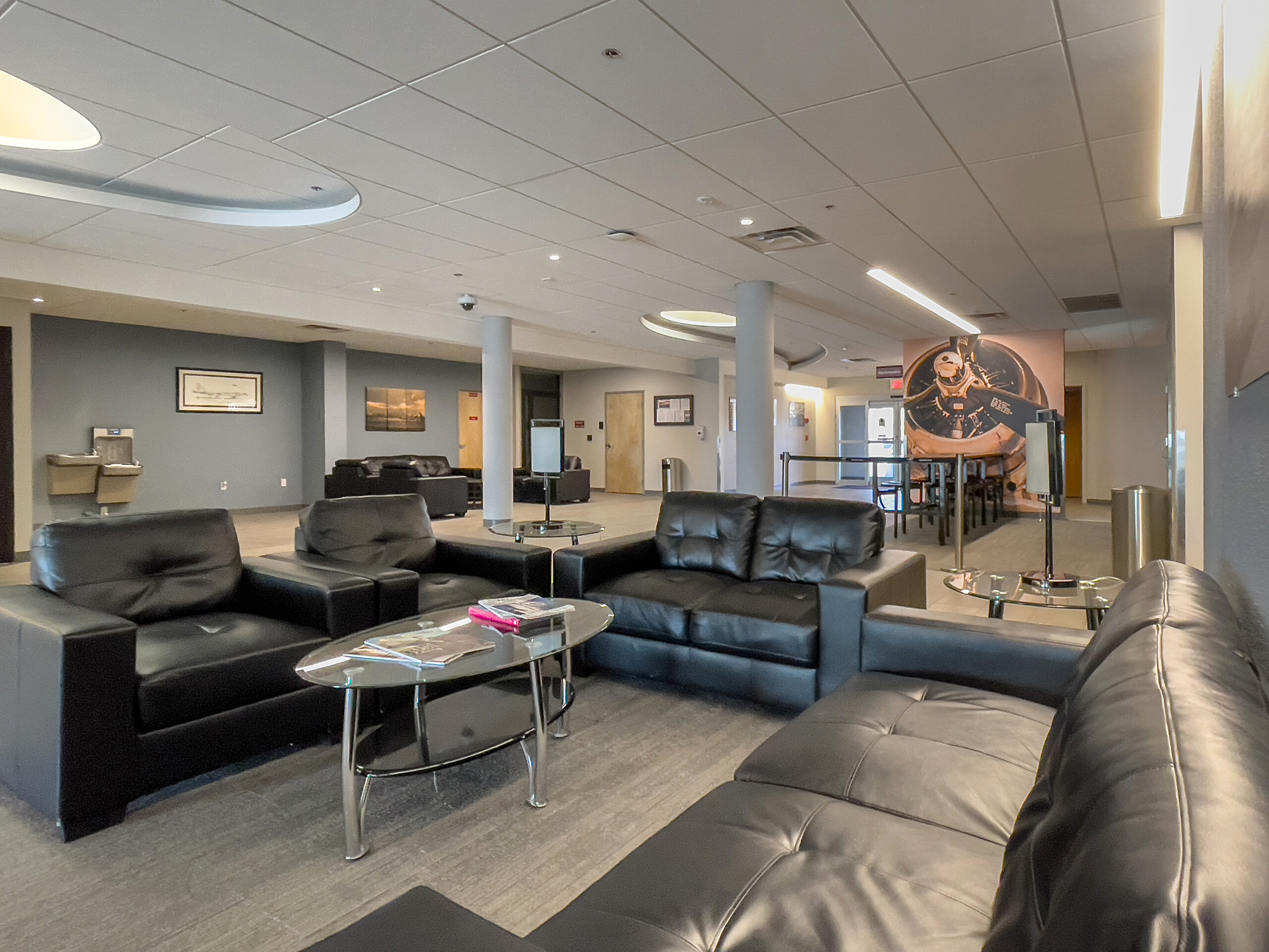 FBO lounge with leather sofas and aviation artwork