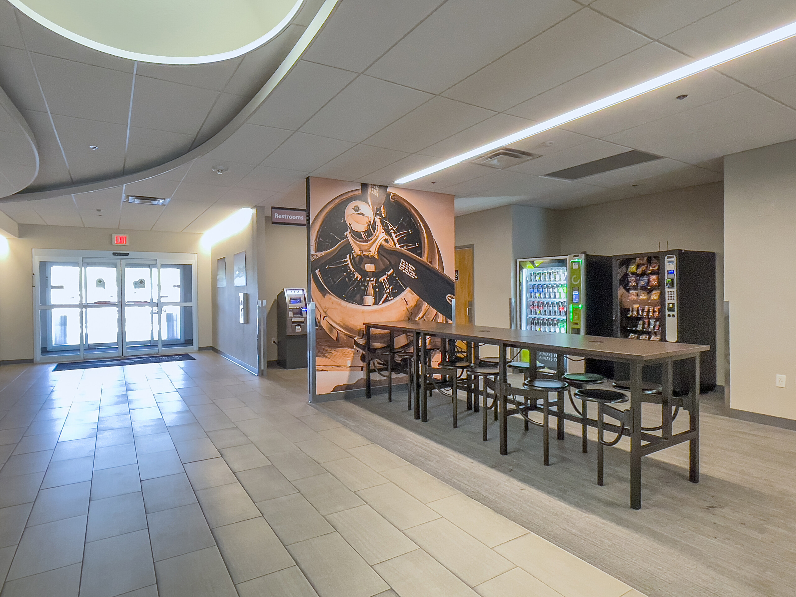 FBO lobby with tables, vending machines and lounge seating