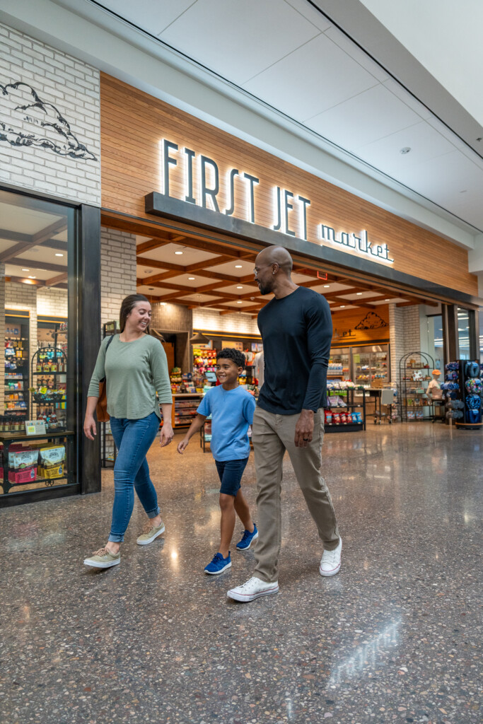 Family walking past the First Jet Market store