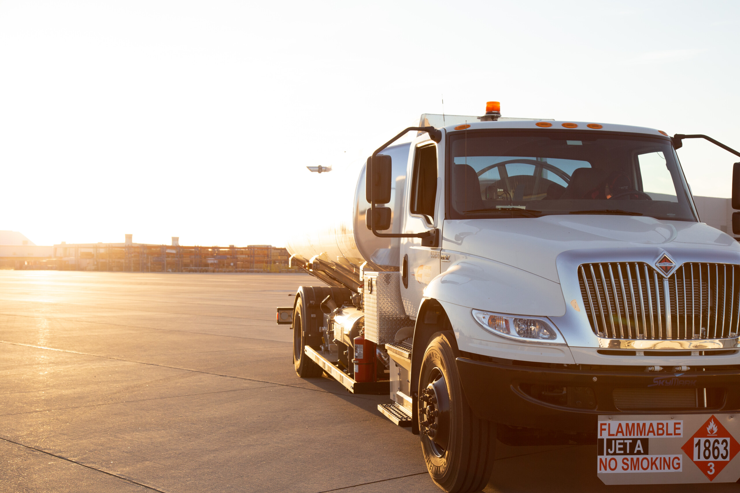 Fuel truck parked on the ramp at sunset