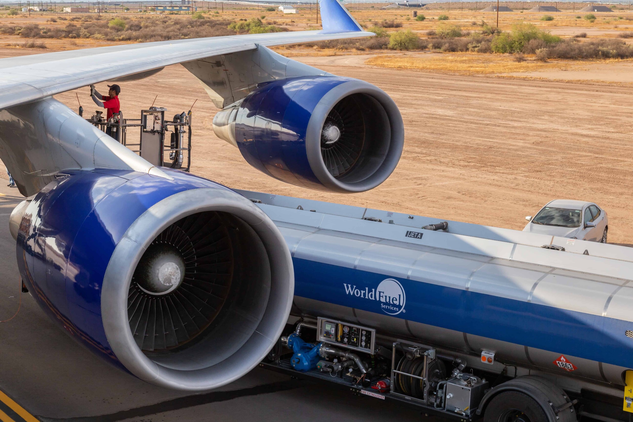 Fuel truck beneath the wing of a large cargo jet
