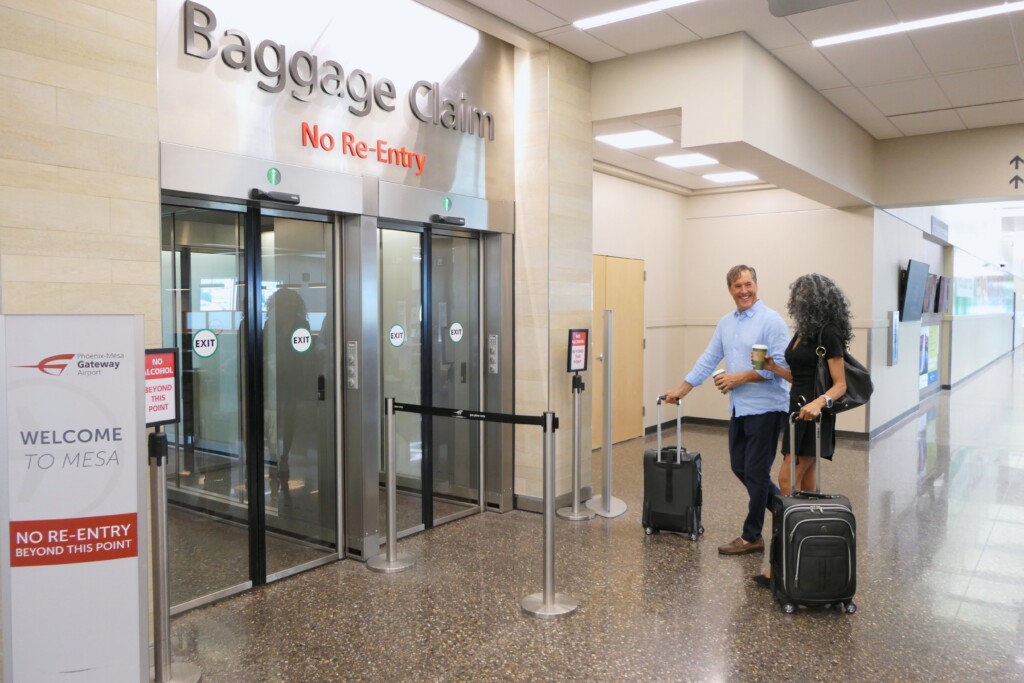 Travelers exiting the baggage claim area