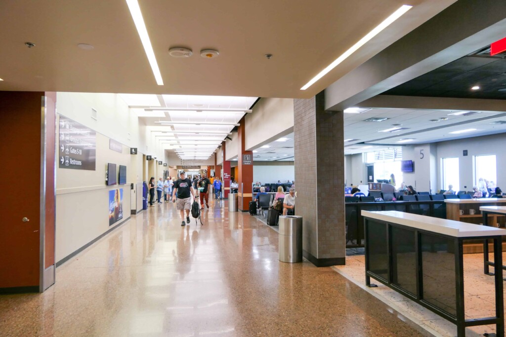 Terminal concourse with seating areas and travelers