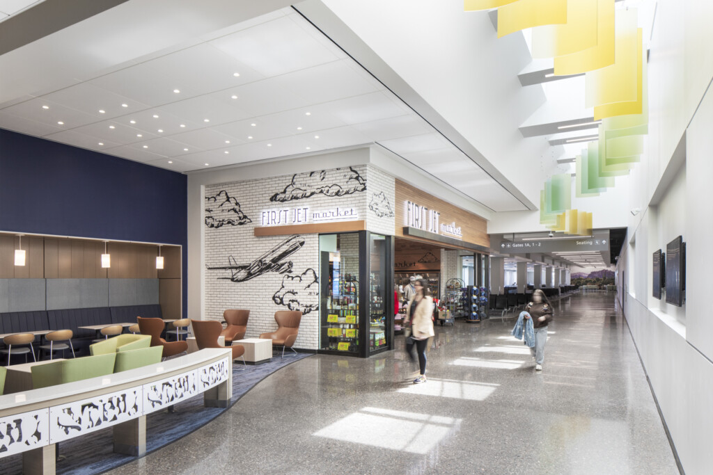 Terminal food court with colorful ceiling panels and seating