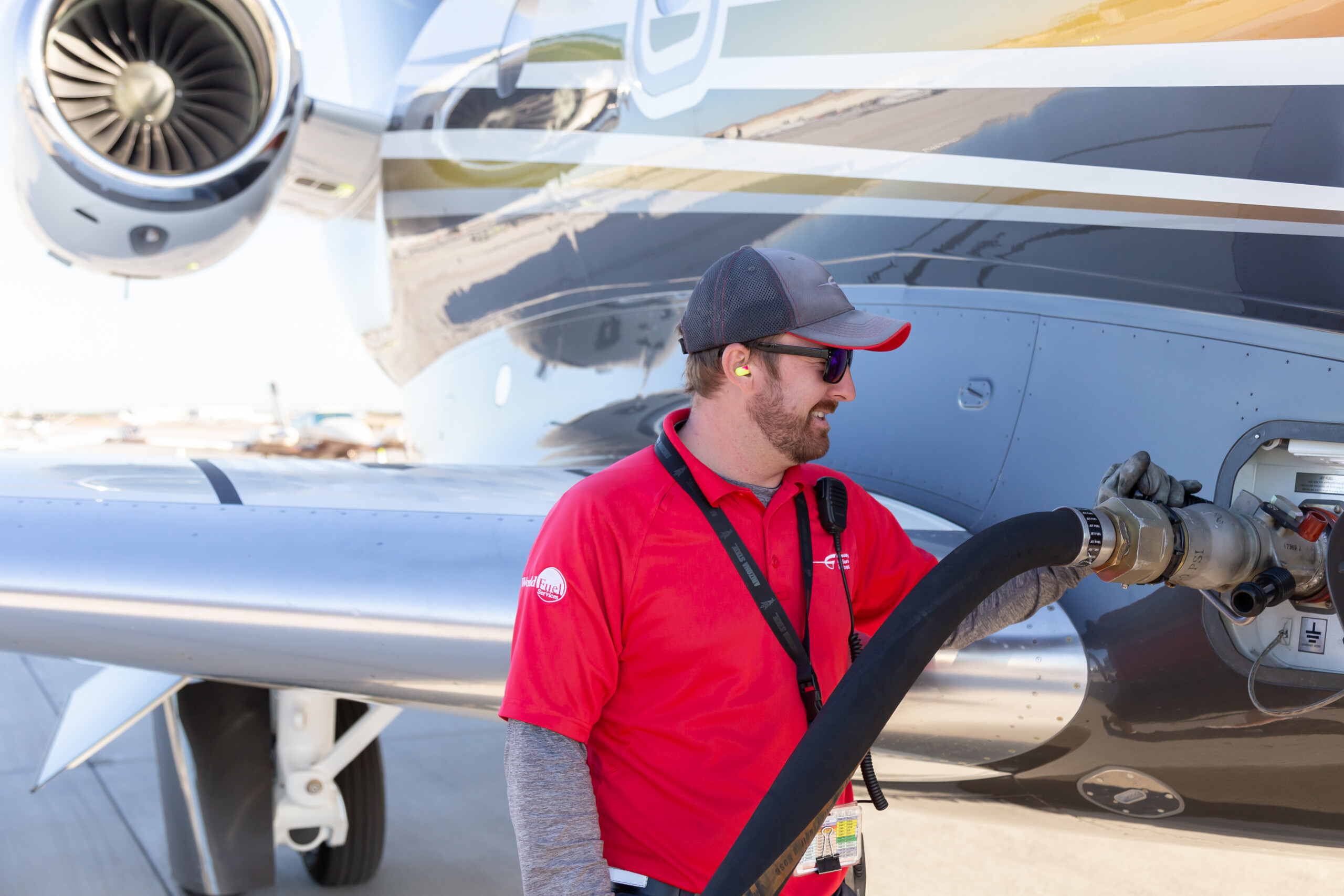 Line technician refueling a private jet
