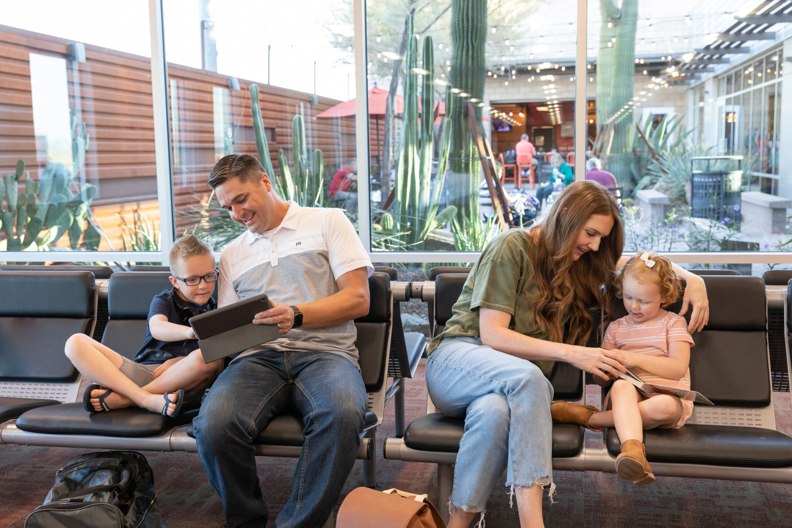 Family with young children relaxing in gate seating by the courtyard windows
