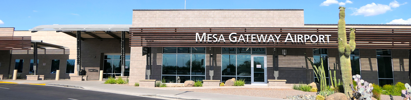 Front entrance of the Mesa Gateway Airport terminal with desert landscaping