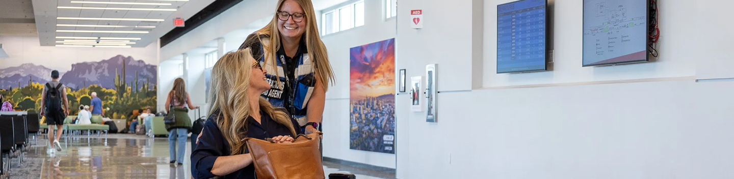 Travelers walking past artwork displayed in the terminal