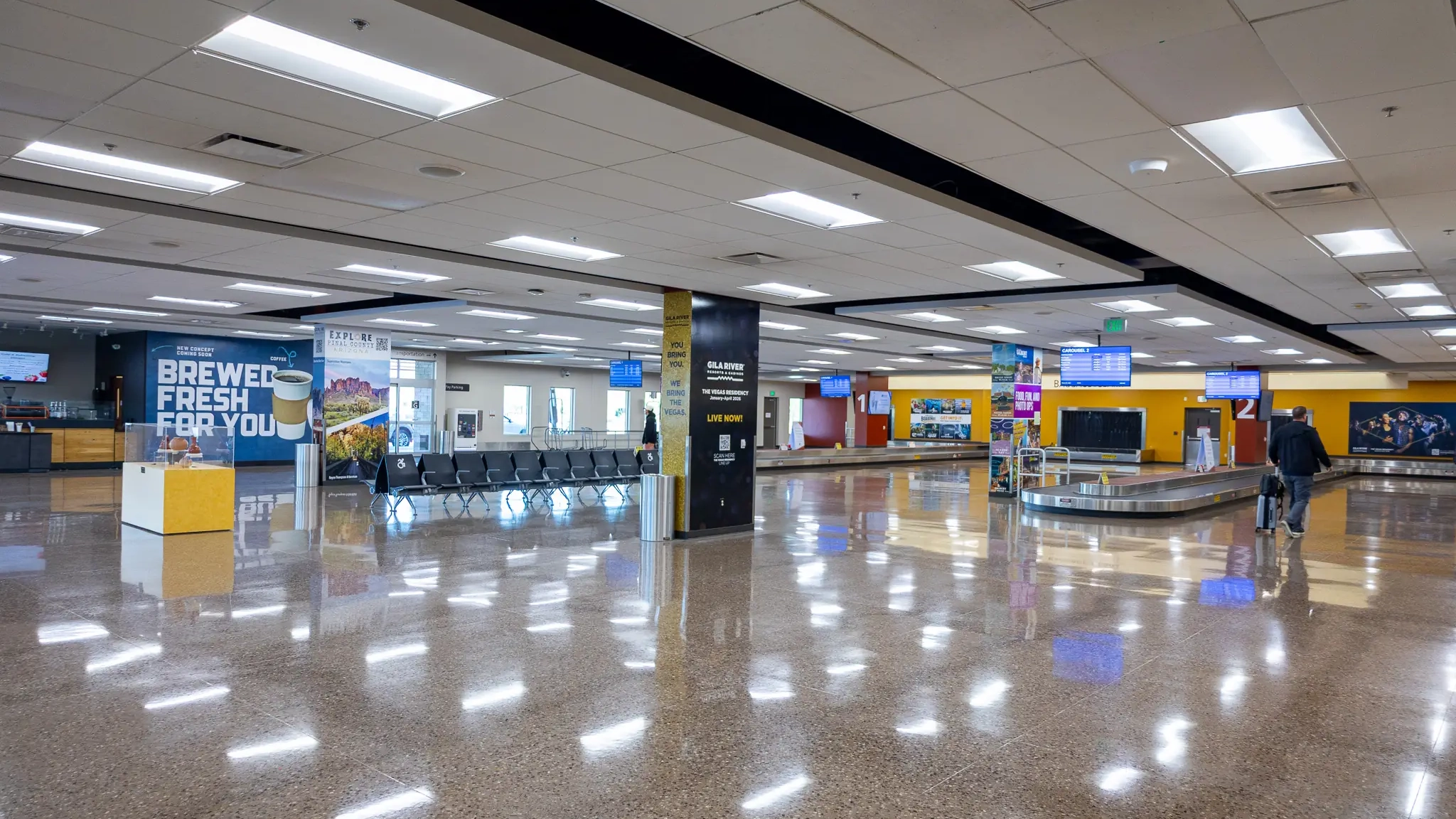 Terminal lobby with digital advertising screens and the coffee shop sign