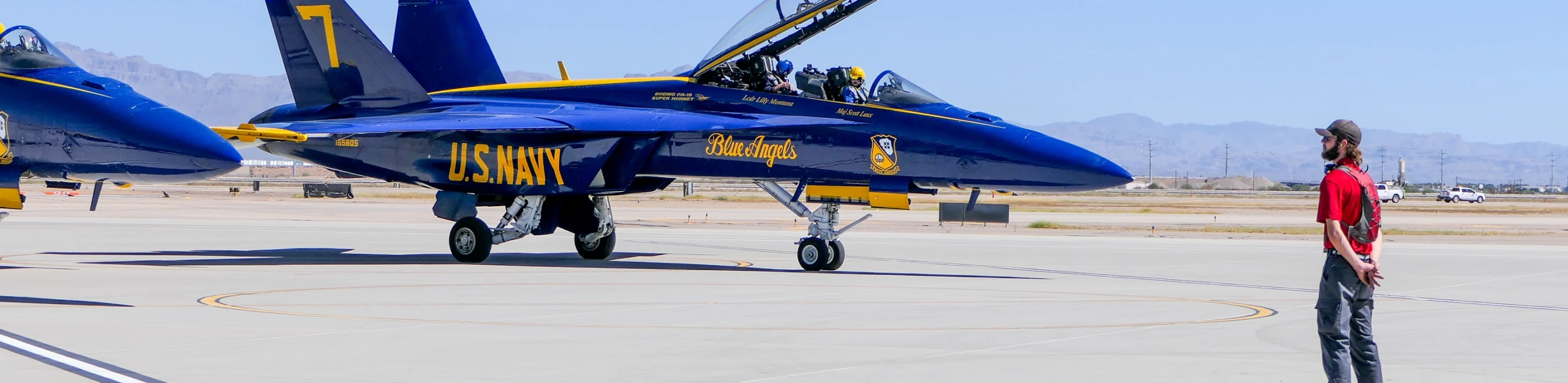 Gateway Aviation Services Line Service Specialist waiting to marshall a Blue Angel pilot